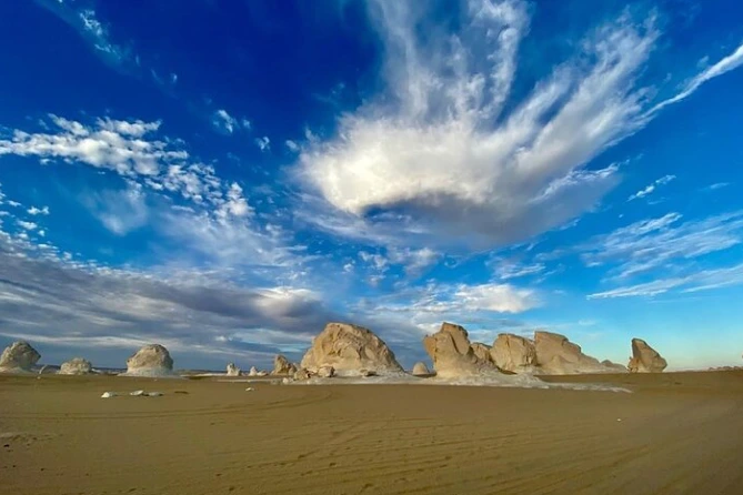 Rock formations in Egypt’s White Desert shining under golden sunset light a must-see on every Egypt desert safari.