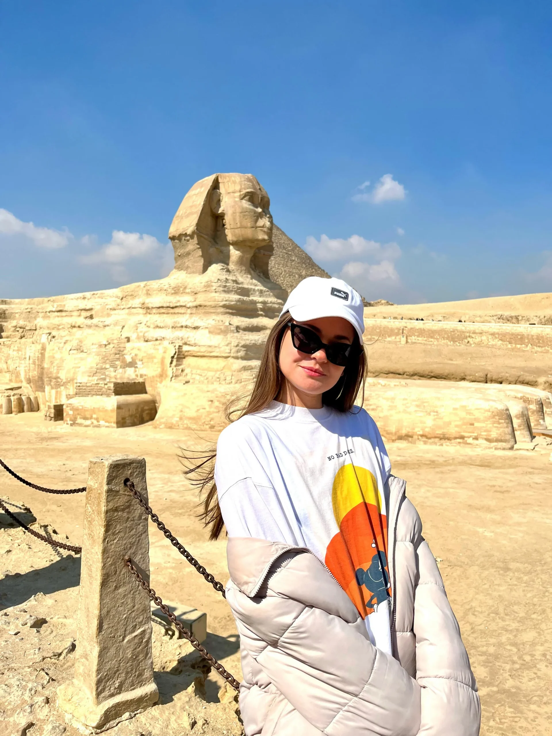 Tourists exploring Egypt for the first time with Heart Egypt Tours, walking near the Pyramids of Giza under the warm Egyptian sun.